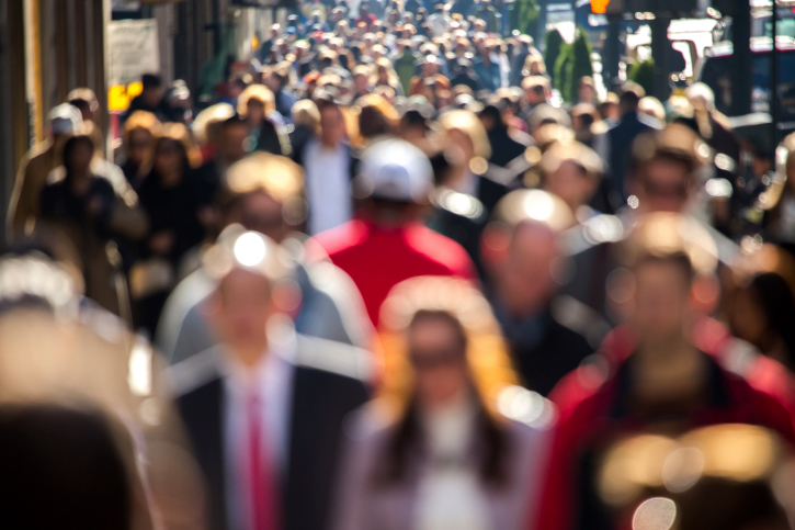 Anonymous crowd of people walking street