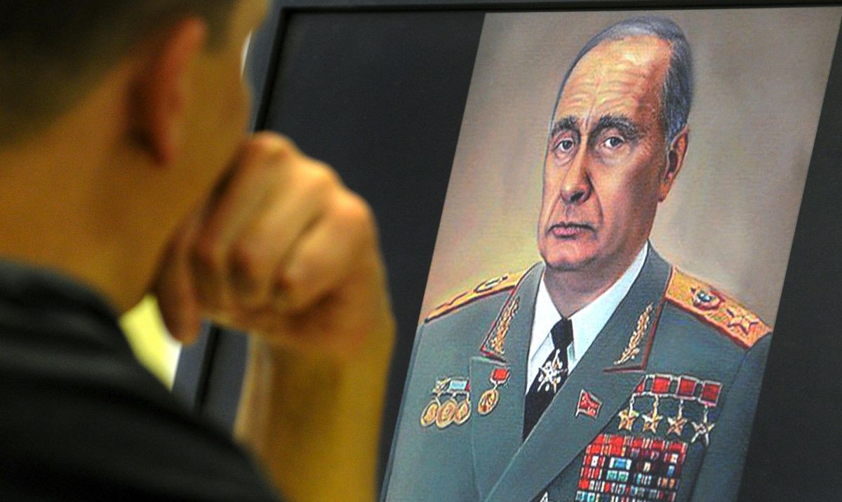 A man looks at a caricature depicting Russian Premier Vladimir Putin as Leonid Brezhnev on his computer screen in Moscow on October 5, 2011